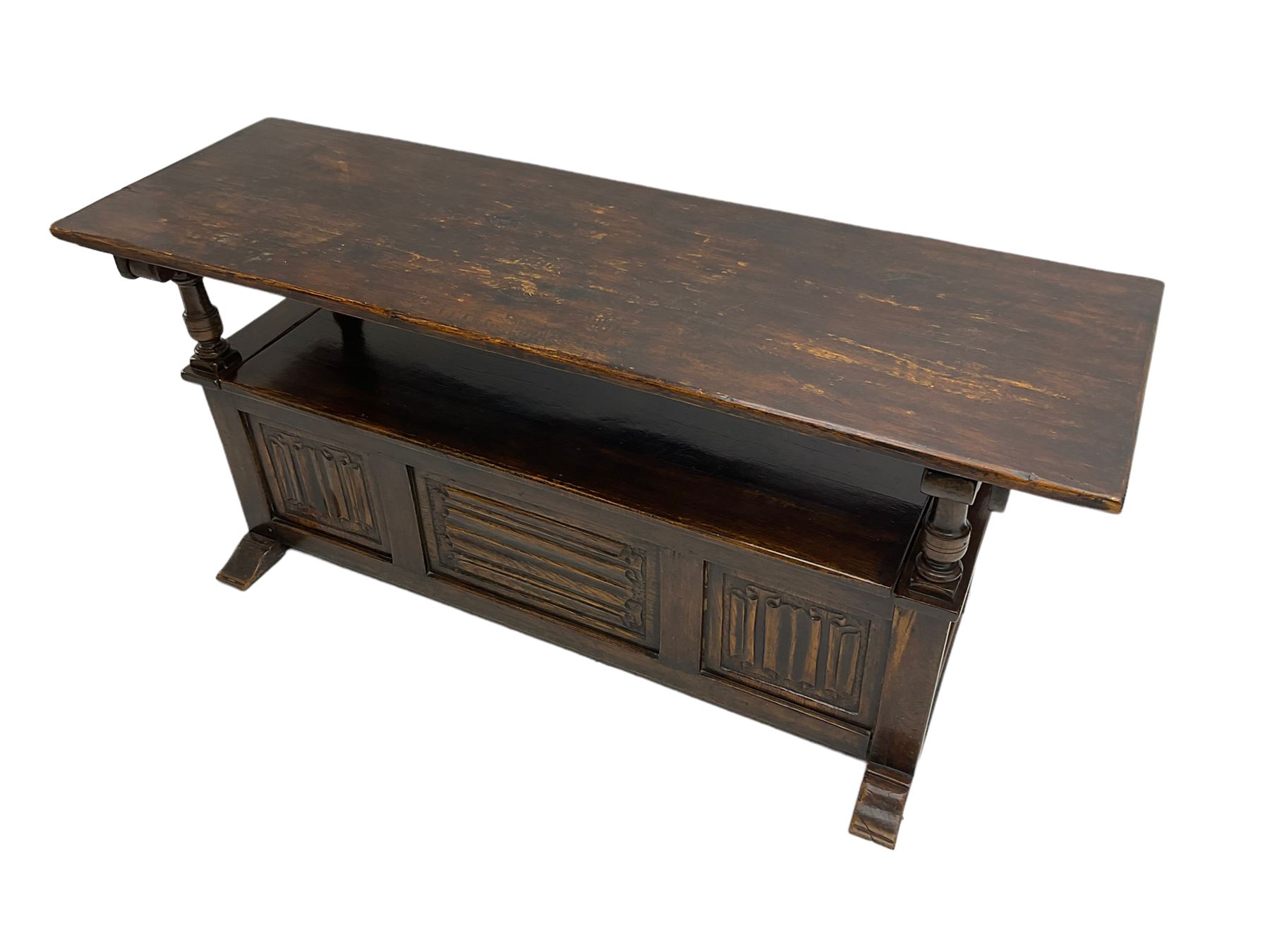 Jacobean design oak Monks bench, the front with carved linenfold panels, hinged metaphoric table back, hinged box seat compartment, on sledge feet