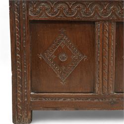 18th century oak coffer or blanket box, triple panel hinged lid over panelled front and sides, the front carved with scrolling foliate motifs and lozenges, moulded frame with chip carved decoration on stile supports 