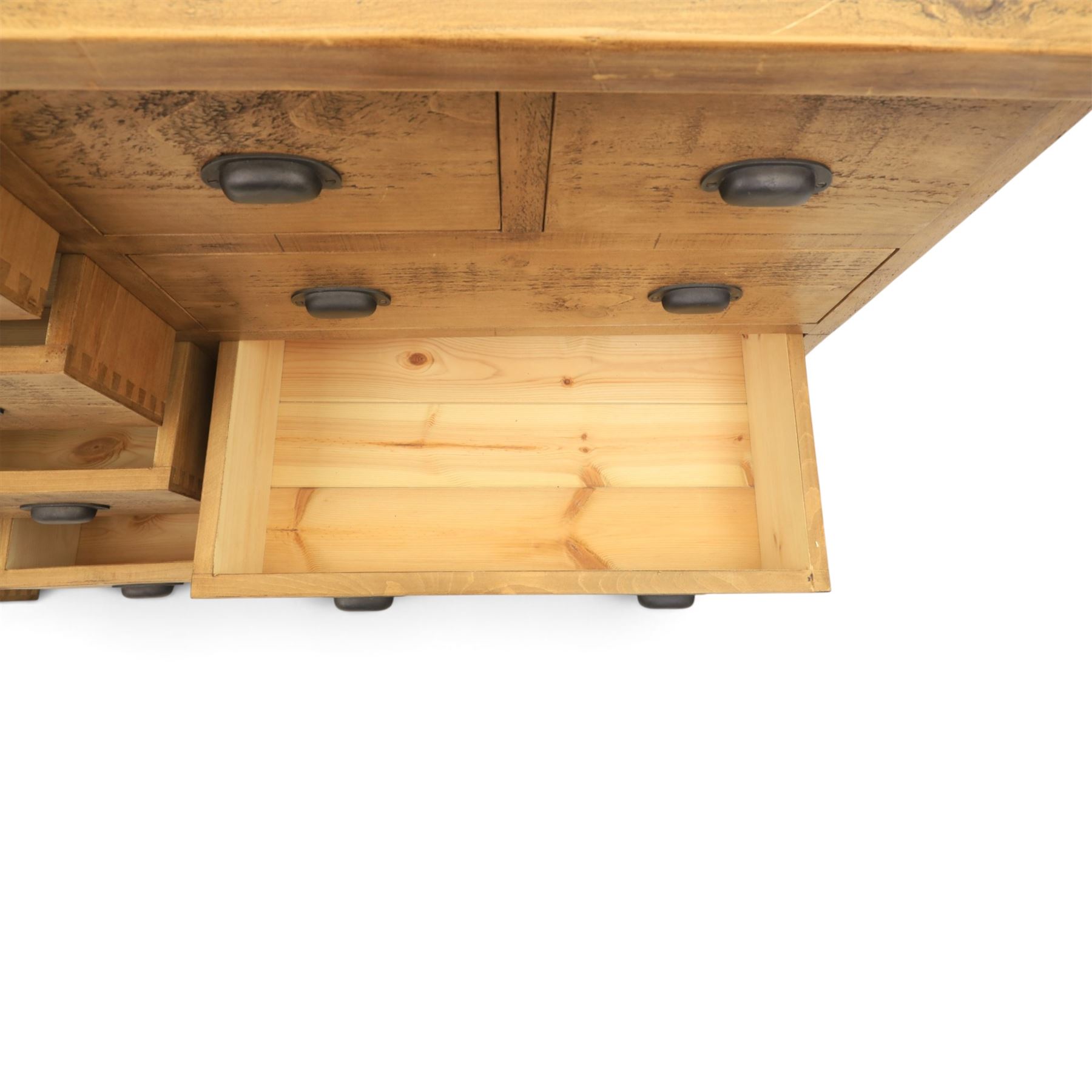 Indigo Furniture - large rustic oak combination chest sideboard, fourteen drawer with blackened metal cup handles, on a plinth base