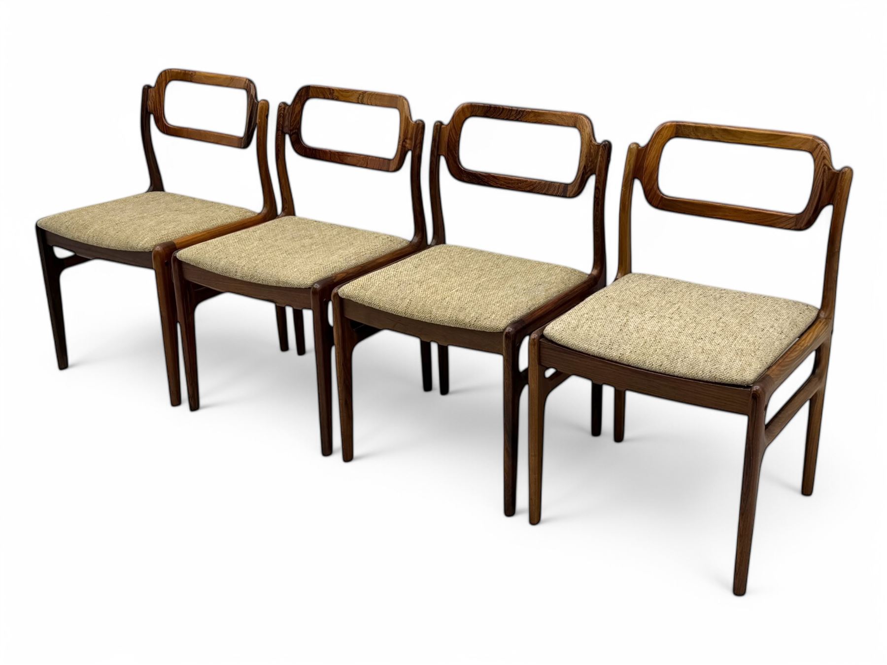 Johannes Andersen for Uldum Mobelfabrik - set of eight Danish teak dining chairs, each with open back rests with curved edges, upholstered seats in a neutral woven fabric, raised on tapered supports