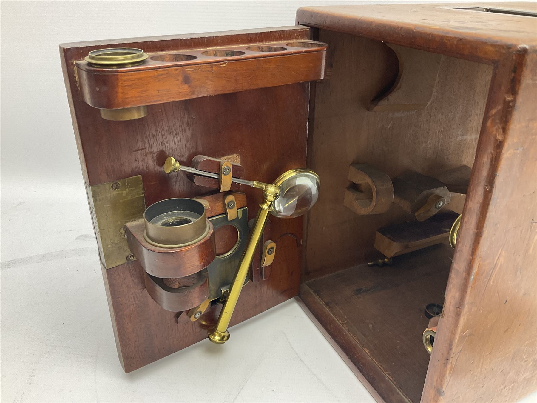 Mid 19th century brass monocular microscope by Andrew Ross, London No.180, with pitchfork base, rack and pinion focusing, revolving bed and swivelling barrel, with accessories, housed in a mahogany case with recessed carry handle and lockable doors