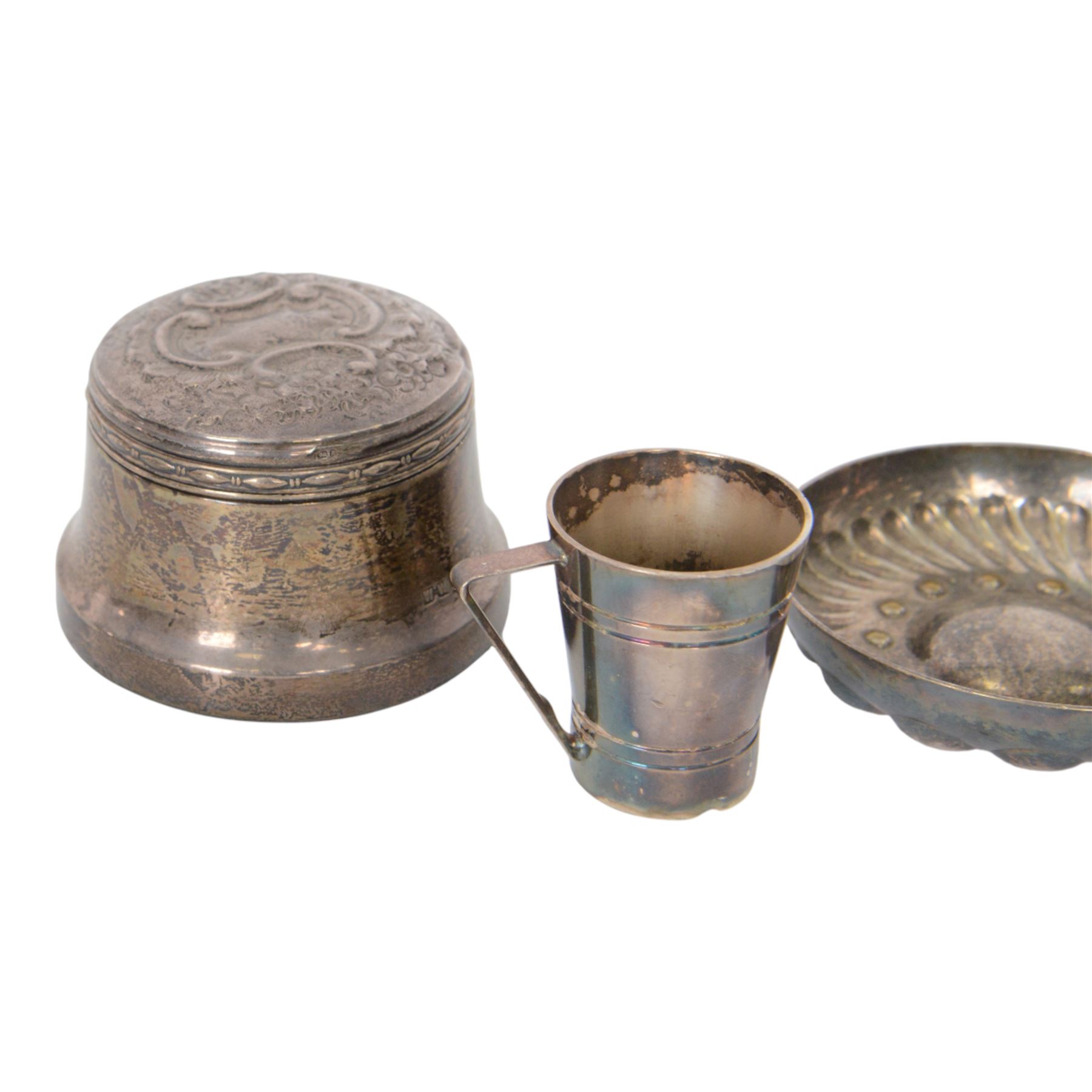Silver mounted trinket box, with embossed lid, hallmarked, silver lidded glass jar stamped sterling, silver plated measure and a silver plated dish