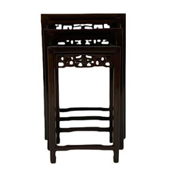 Early 20th century Chinese rosewood nest of three tables, with decorative carved and pierced frieze panels