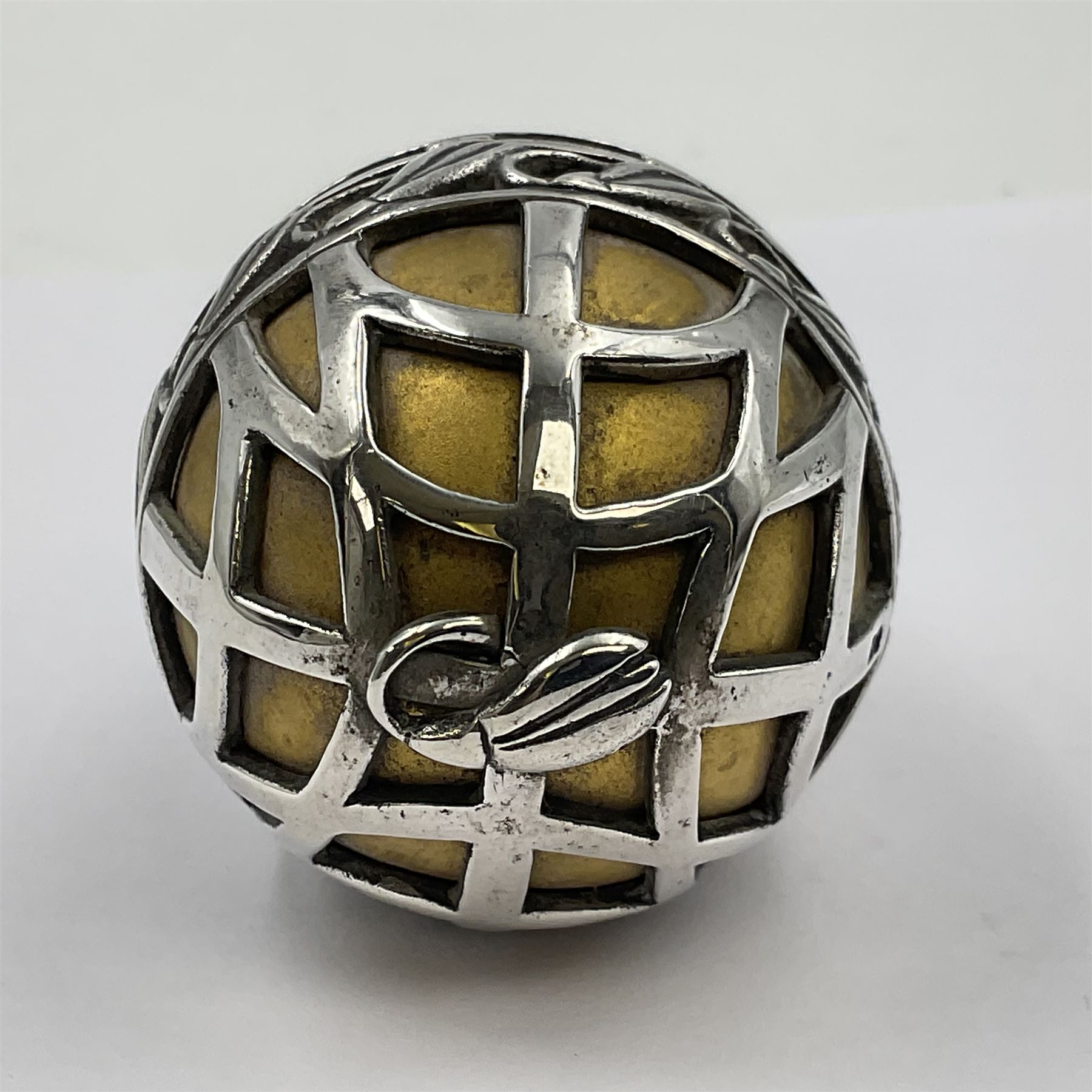 Modern silver limited edition Easter egg, no. 70/500, the gilded body decorated in relief with silver latticework and a band of flower heads, the detachable cover opening to reveal a gilt interior, each hallmarked St James House Company, London 1978, H5.5cm