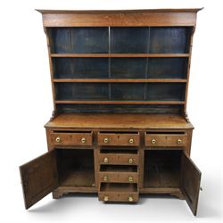 18th century Georgian oak dresser and rack, three back-boarded plate shelves, above six drawers and two cupboards, raised on bracket feet