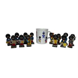 Fourteen Golly Band figures, eight labelled Robertson to base, and TAMS golly mug