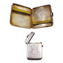 1920s silver cigarette case, of rectangular form, with engraved scroll decoration and later applied engraved circular central panel, hallmarked W H Haseler Ltd, Birmingham 1920, together with an early 20th century silver vesta case, of typical form, engraved with monogram with push button release cover, hallmarked Horace Woodward & Co, Birmingham 1905, and a tapering silver watch chain with clip, hallmarked on clip and with lion passant to each link

