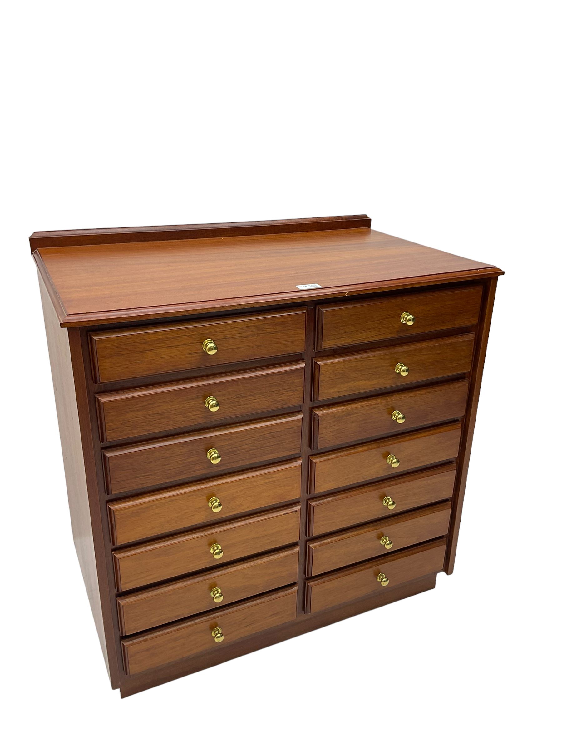 Late 20th century teak sheet music cabinet, fitted with fourteen drawers on plinth base 