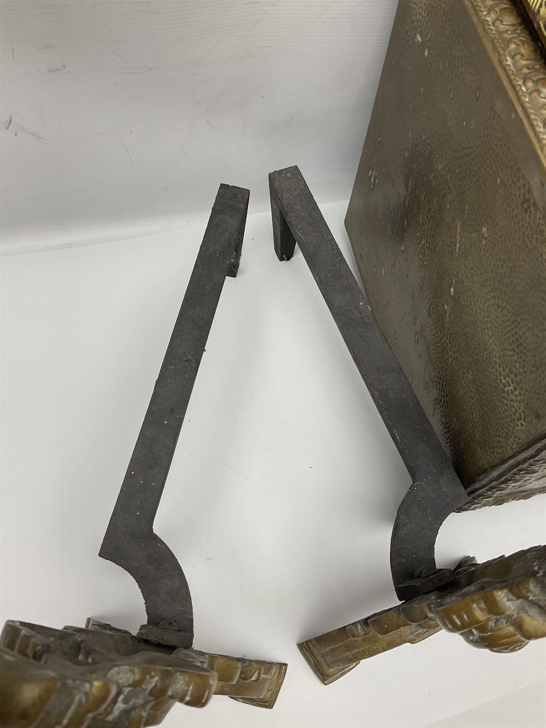 Pair of brass and iron fire dogs, together with brass coal box embossed to the lid with figures and a brass magazine rack, coal box H32cm