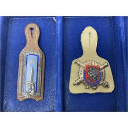 Twelve French military metal badges mounted on leather fobs including Legion, Artillery, Parachutist, Air Force, Infantry etc