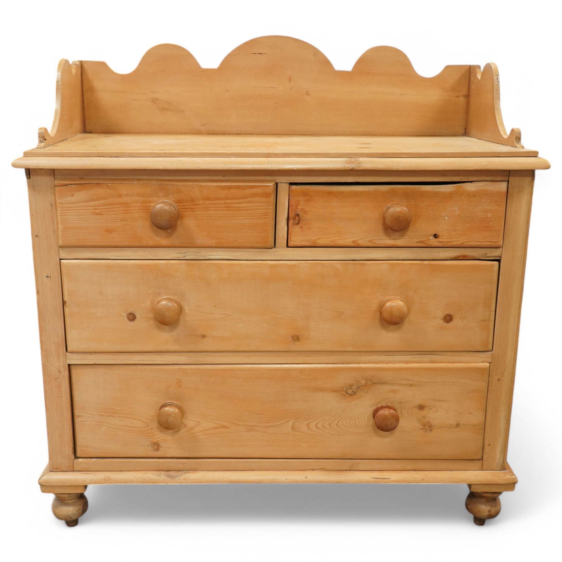 Victorian pine pot cupboard washstand, shaped arched gallery back with scroll carved ends, rectangular top over two short and two long drawers with turned wooden knobs, raised on squat turned feet