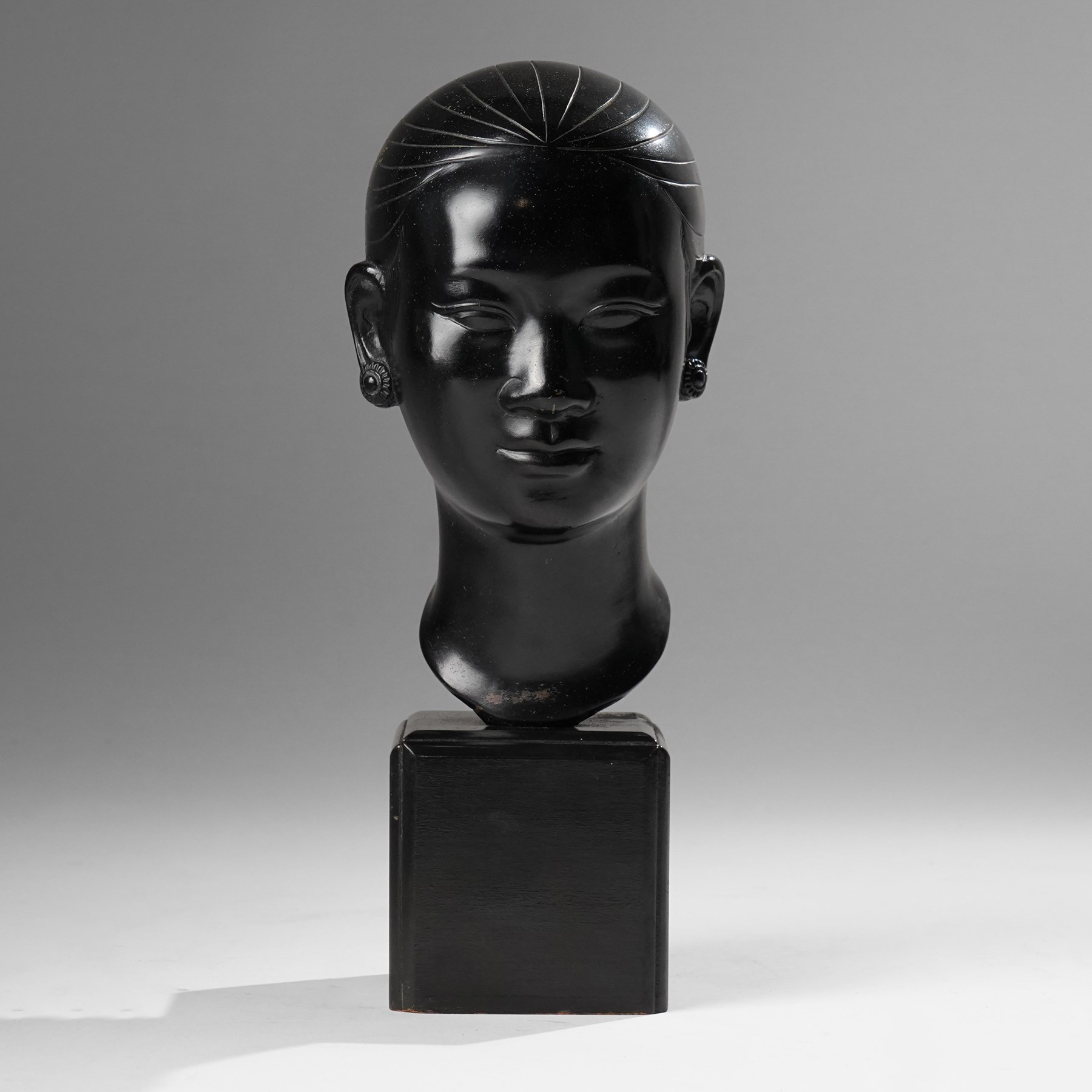 Manner of Nguyen Thanh Le (Vietnamese 1919-2006): Head of a Woman, bronze bust with indistinct character signature to neck, on ebonised base, H27cm 