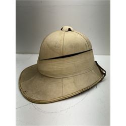 WWII Royal Navy officers sun helmet with large folded pagri and black top line, interior with green cloth covering to the peaks and original leather sweatband, with makers label 'Gieves Ltd London', with its original storage tin with indistinct painted lettering to the front 