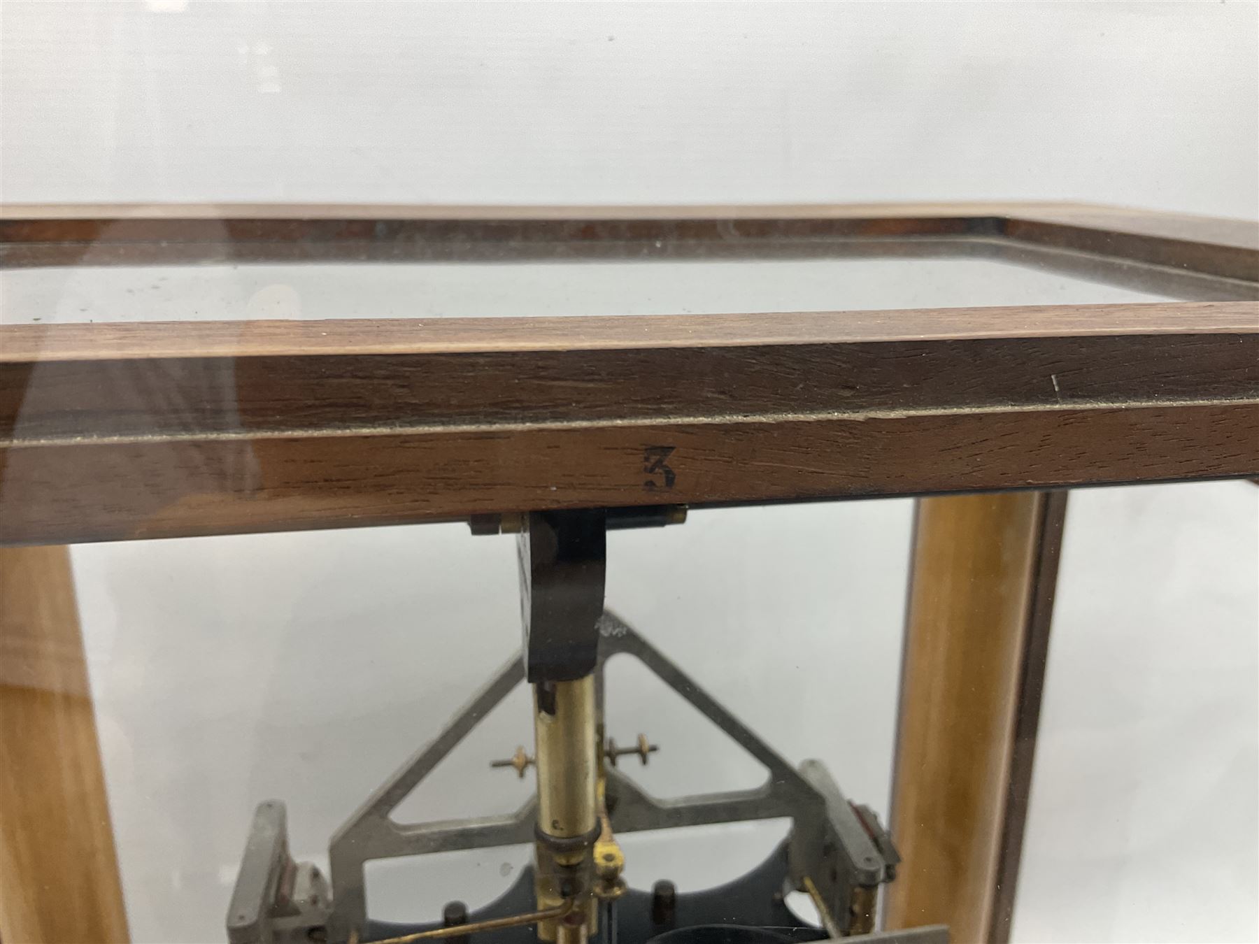 Set of laboratory balance scales by Reynolds & Branson of Leeds in fully glazed mahogany case with rise-and-fall front door, black vitrolite base with brass feet and hand cranked action L40cm H51.5cm D30cm; and bakelite cased set of brass weights