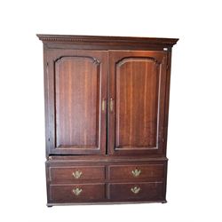 George III oak press cupboard, dentil cornice over two arch fielded panel doors, the base fitted with four drawers with pressed brass handle plates