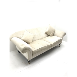 Three seat sofa upholstered in an cream chenille fabric, scrolled arms, turned supports, W220cm