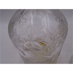 Two modern silver mounted decanters, the first example with etched and cut fruiting vine decoration to glass body, with faceted stopper, hallmarked C J Vander Ltd, Birmingham 1980, the second smaller example, with oval cut decoration and flambe type stopper, hallmarked S J Rose & Son, Birmingham 1985, tallest H28.5cm