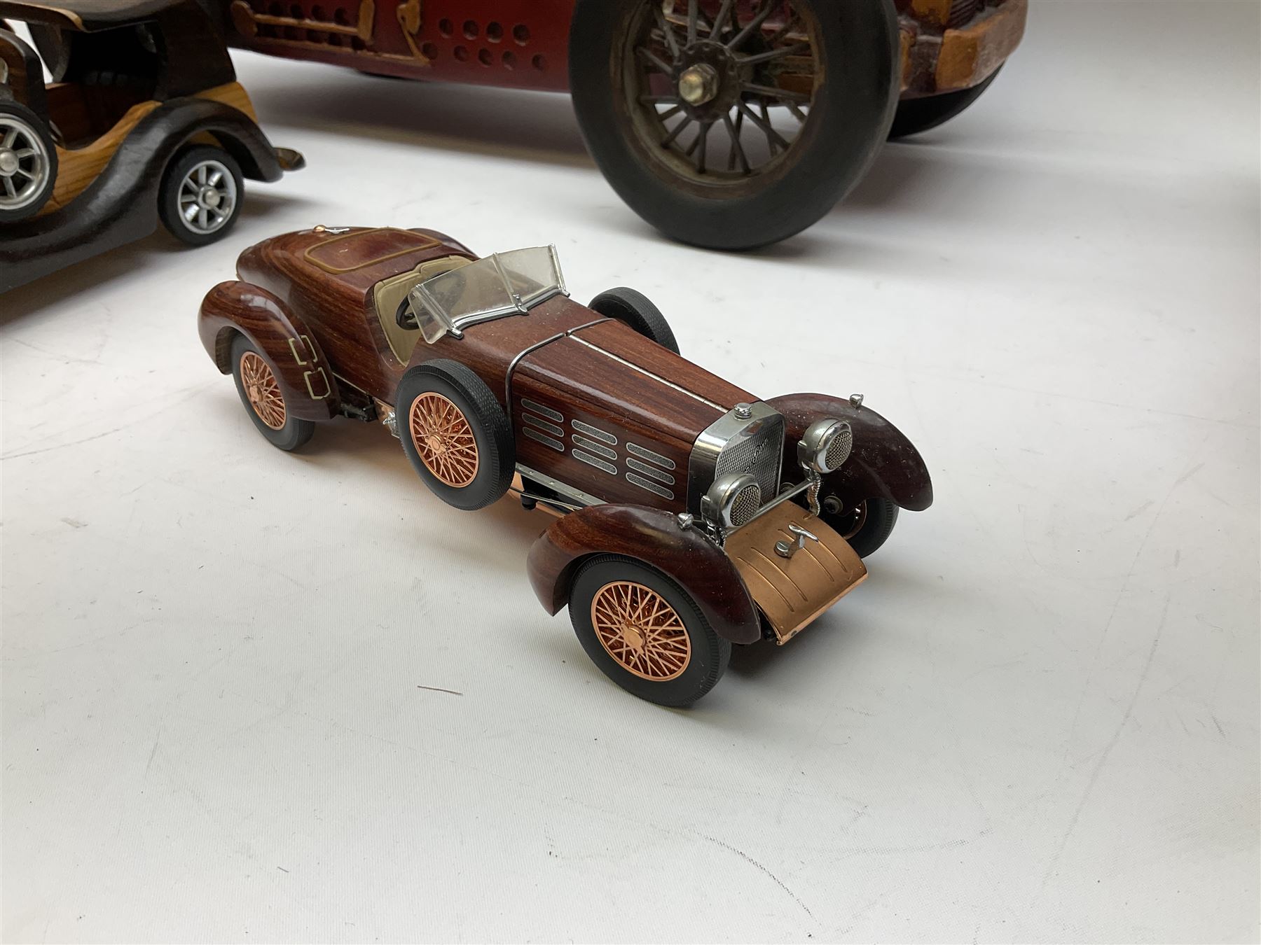 Four Franklin Mint Precision Models, one with hardwood body; large reproduction model of a vintage racing car L52cm; and four other modern metal/wooden models of vintage cars; all unboxed (9)