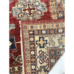 Turkish style red ground rug, repeating border, central medallion, 250cm x 160cm