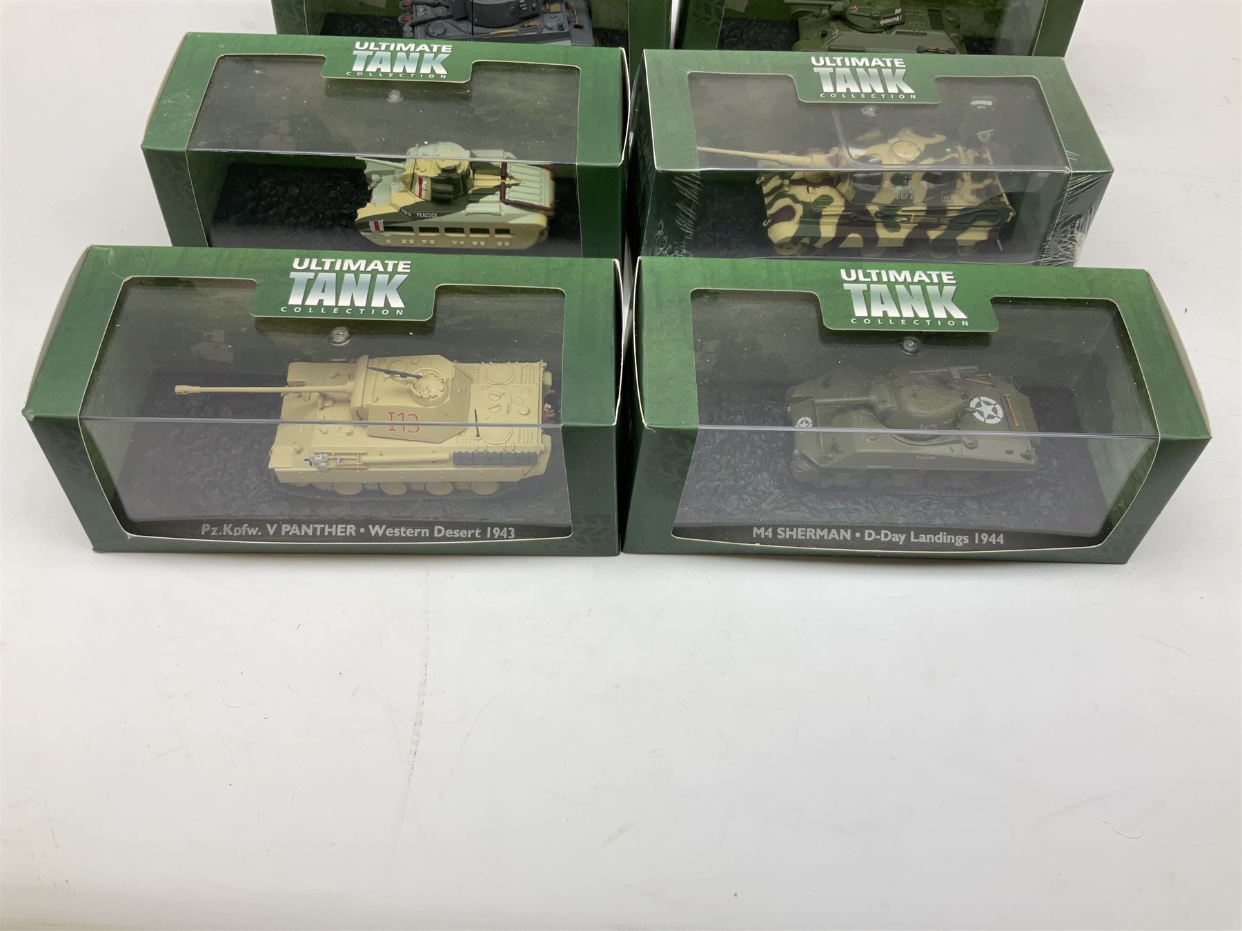Sixteen Atlas Editions die-cast models of military vehicles including six Ultimate Tank Collection; all in perspex display cases; fourteen boxed; with associated paperwork (16)