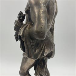 20th century silver plated figure, modelled as a classical male figure, possibly Prometheus, holding flames, one foot resting atop a small dragon, upon a circular spreading base, overall H37.5cm