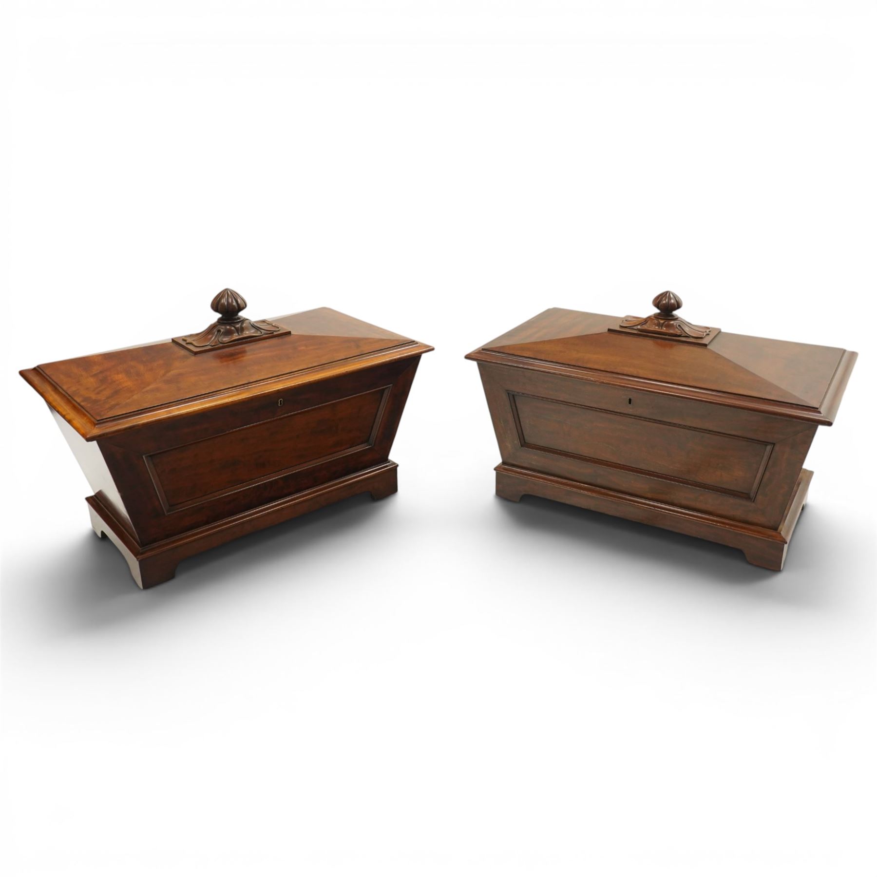 Thomas & George Seddon (1815-1870) - Pair of mid-19th mahogany cellarettes of sarcophagus form, the hinged and panelled top surmounted by a gadrooned and lappet carved knop, surrounded by a moulded edge, enclosing a lead lined wine cooler interior to one, the other paper lined, lower moulded edge over bracket feet and castors