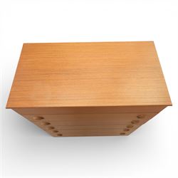 Mid 20th century teak dressing chest, rectangular top hinged to reveal a fitted interior with divisions and a rectangular mirror to the underside, over five long drawers with recessed circular handles, raised on tapering supports