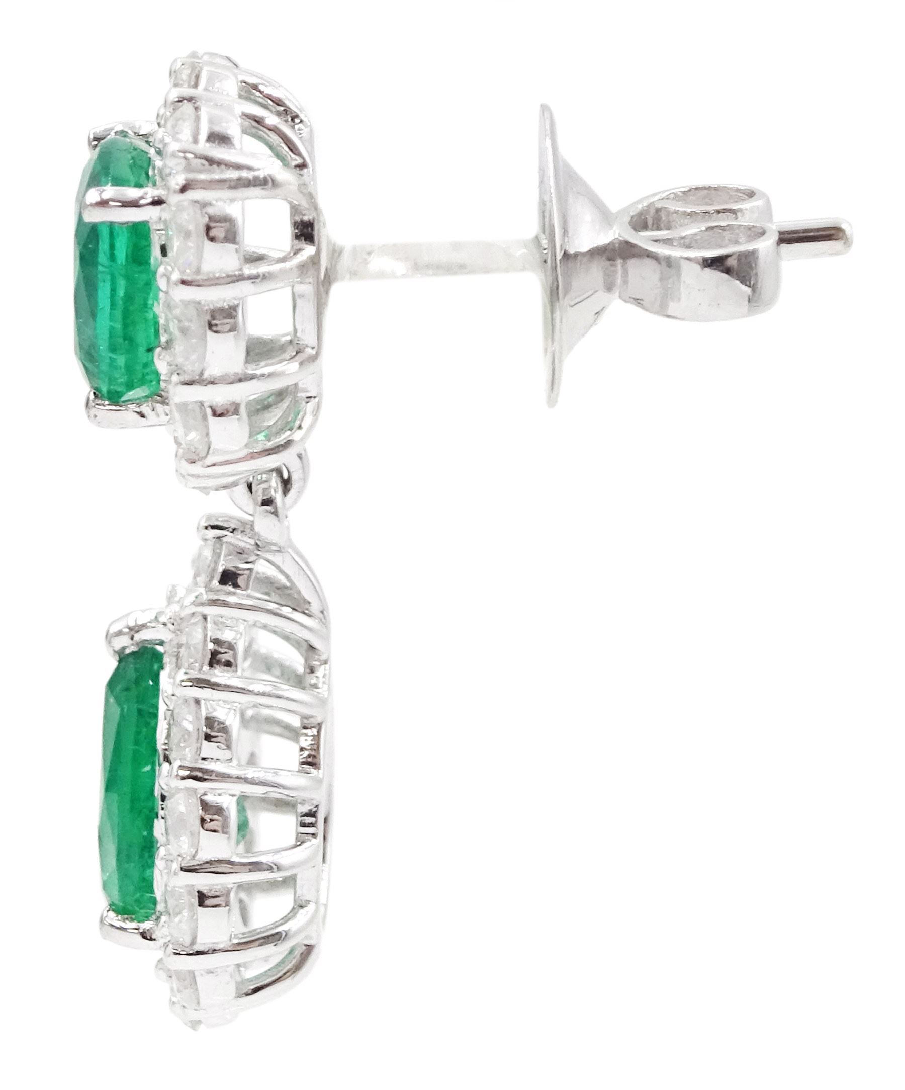 Pair of 18ct white gold emerald and diamond pendant earrings, each stud set with a cushion cut emerald and round brilliant cut diamond surround, suspending a further pear cut emerald and diamond cluster stamped, total emerald weight approx 3.45 carat, total diamond weight approx 1.70 carat