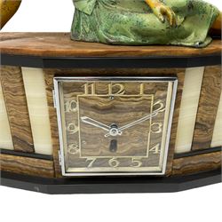 A 1950's Art Deco mantle clock in contrasting black, white and brown onyx marble, surmounted by a reclining spelter figure of a young lady, with a 6” square dial with a chrome bezel, Arabic numerals and chrome baton hands, with a timepiece spring driven movement.  With pendulum.

