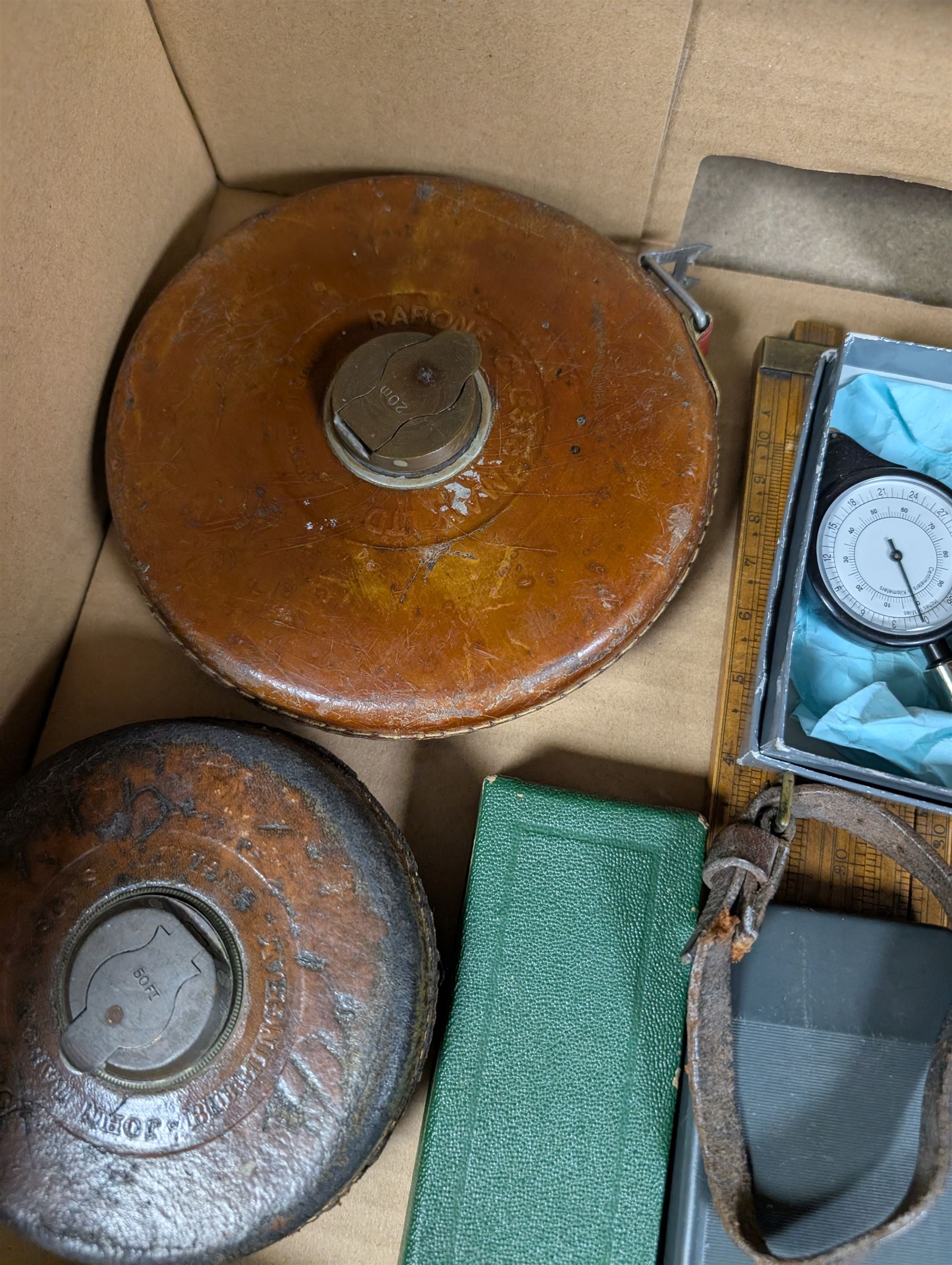 Three Rabone tape measures in leather cases, one with broad arrow, three map wheels, pair of Moore & Wright calipers, W Harling alidade in Whippy leather case with broad arrow and a collection of slide rules