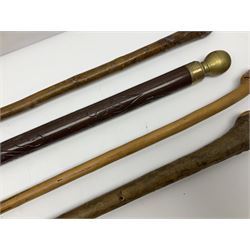 Four wooden walking canes, including a carved mahogany snooker cue example, tallest H86cm