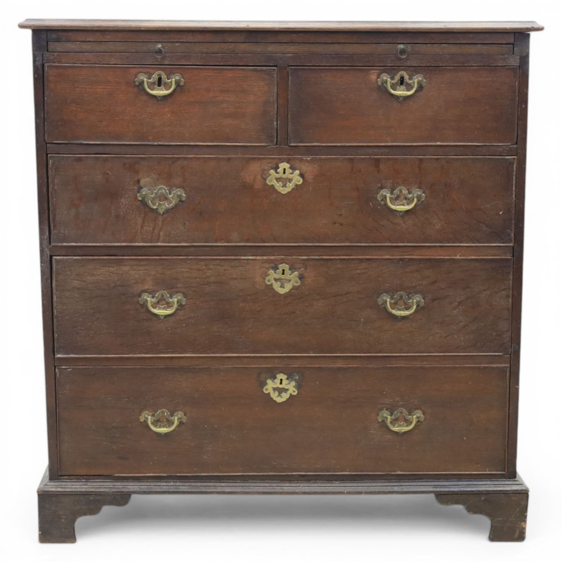 18th century oak chest, rectangular top with moulded edge, fitted with five drawers and baize line slide, with swan neck brass handles, raised on bracket feet