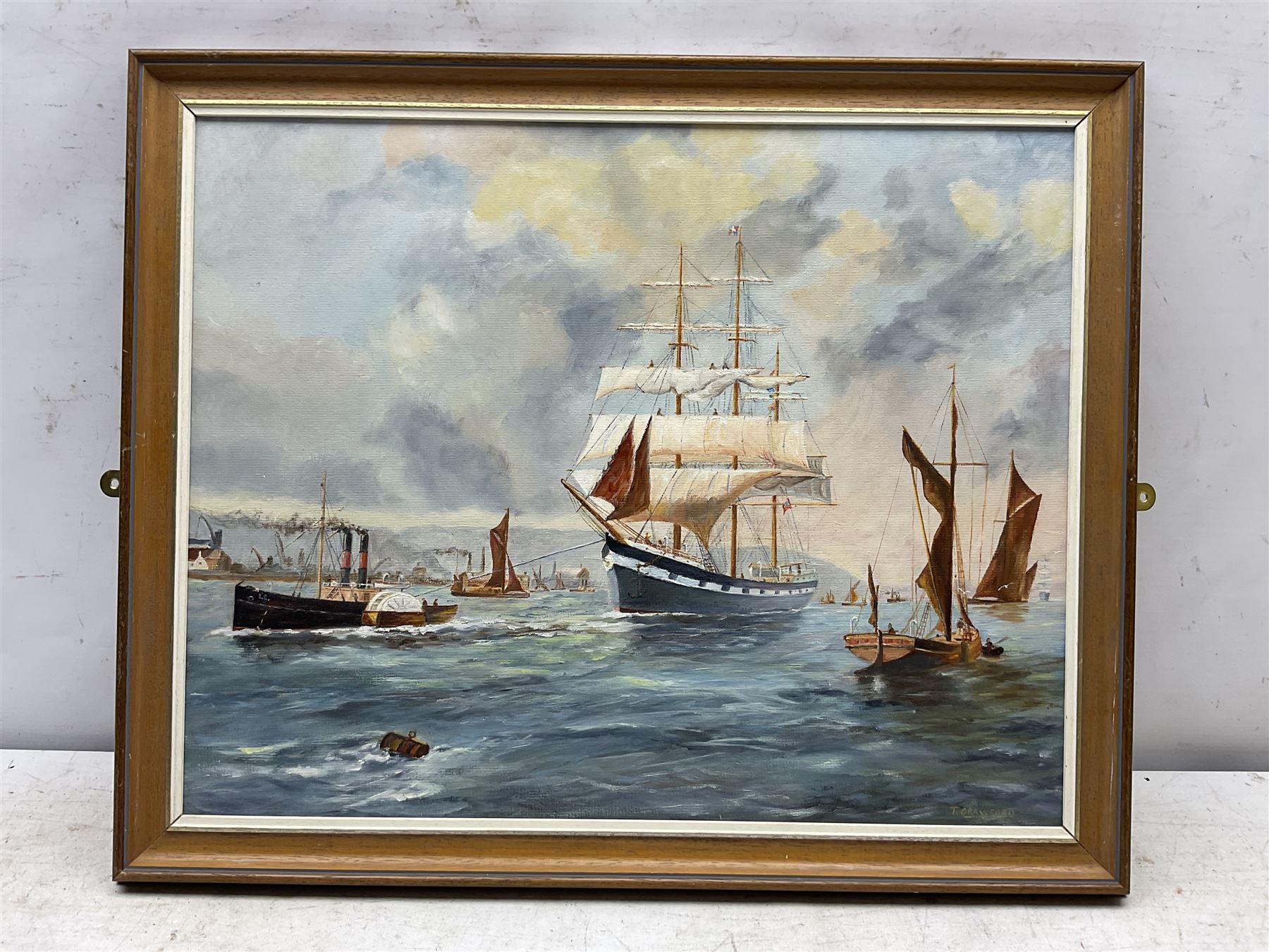 Edward H Simpson (British 1901-1989): 'Scarborough South Bay from Cliff Tops', watercolour signed, titled on label verso 35cm x 53cm;Tom S Hoy (British 20th century): Deck Chairs by the Ocean Room, Scarborough Spa, oil on board signed 30cm x 45cm; T Crawford (20th century): Steam and Sail Vessels, oil on board signed 40cm x 50cm (3)