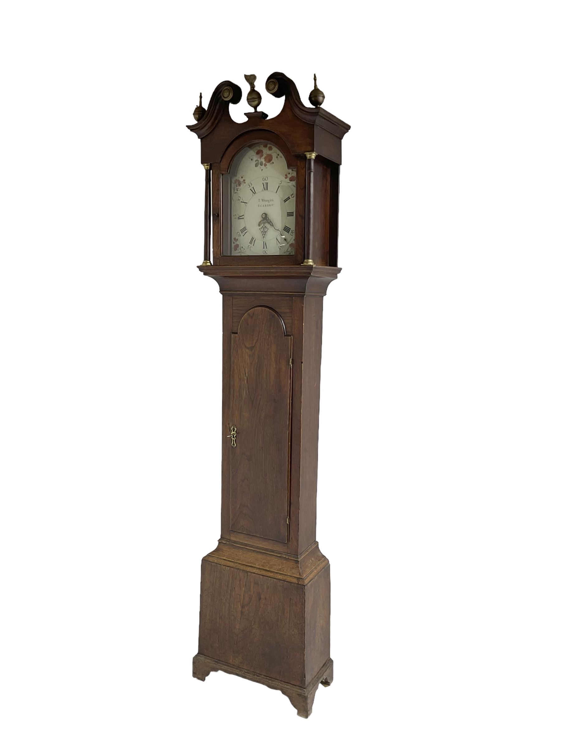 Thomas Wrangles -  early 19th-century oak longcase clock with a swans neck pendulum and three brass finials, glazed hood door flanked by two free standing pilasters, long trunk door with a break-arch top on a square plinth raised on bracket feet, painted dial inscribed T Wrangles Scarboro, dial pinned directly to a 30-hour chain driven count wheel movement striking the hours on a bell.
 With pendulum and weight. 