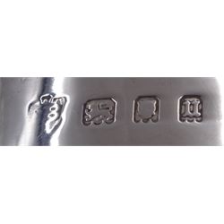 1930s silver part cruet set, comprising mustard pot and cover and open salt, both of circular drum form with oblique gadrooned rim, the mustard pot with capped scroll handle and palmette thumbpiece, both with blue glass liners, hallmarked London 1935, maker's mark worn and indistinct