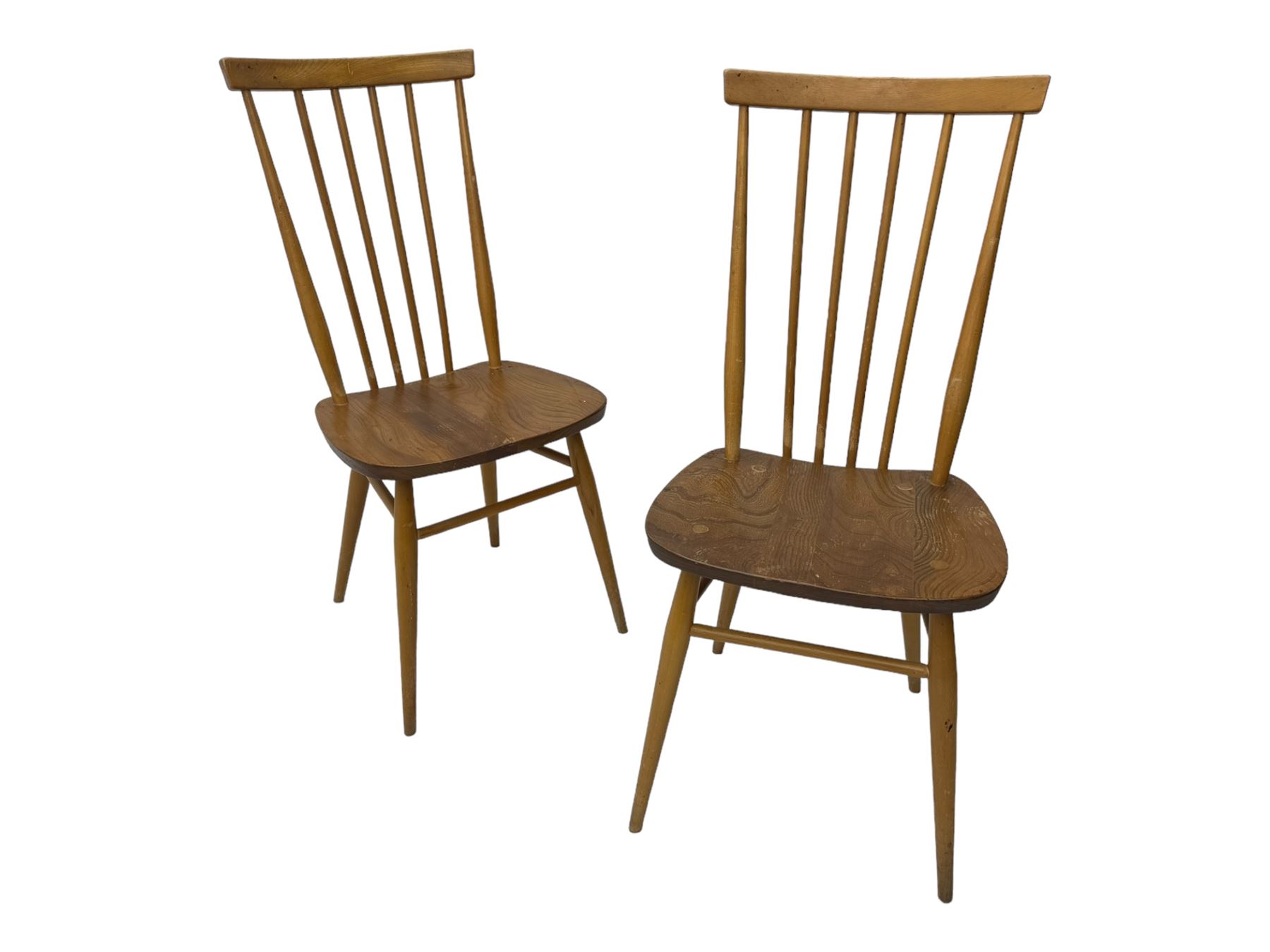 Ercol - pair of mid-20th century highback 'Windsor' chairs, curved top rail over six vertical spindles and shaped seat, on tapering cylindrical supports with stretchers