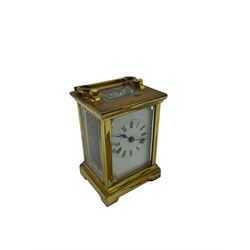 A compact late 19th century French carriage clock with a lever platform escapement, enamel dial with Roman numerals, minute markers and steel spade hands, four bevelled glass panels and a rectangular panel to the top of the case. No key. H10cm