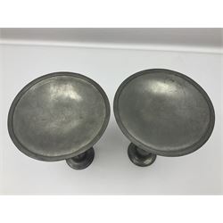 Pair of Solkets English pewter candlesticks, the bud shaped sockets raised upon three angular fin supports and a slightly domed circular base with cast stylised foliate decoration, H23cm
