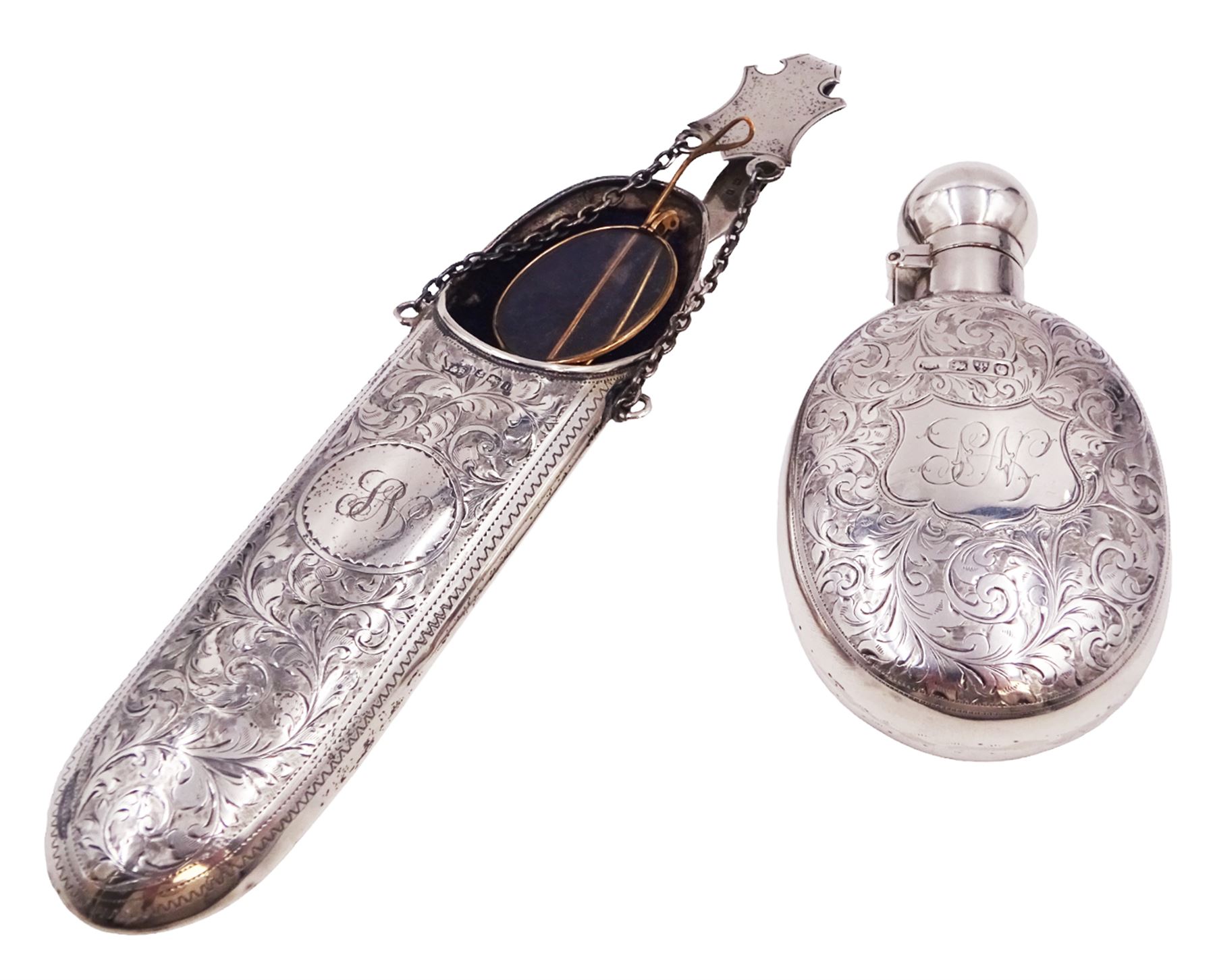 Victorian silver hip flask, of oval form, with engraved foliate and scroll decoration, and monogrammed shield shaped cartouche to centre, with plain collar and cap, H11cm, hallmarked Chester 1899, maker's mark worn and indistinct, together with an Edwardian silver glasses case, of oval form, with engraved foliate and scroll decoration, and monogrammed circular shaped cartouche to centre, with opening to top, revealing velvet lined interior, with silver shield clip, H17.5cm hallmarked to case and clip Sanders & Hill,  Birmingham 1908, with a pair of gold plated glasses 