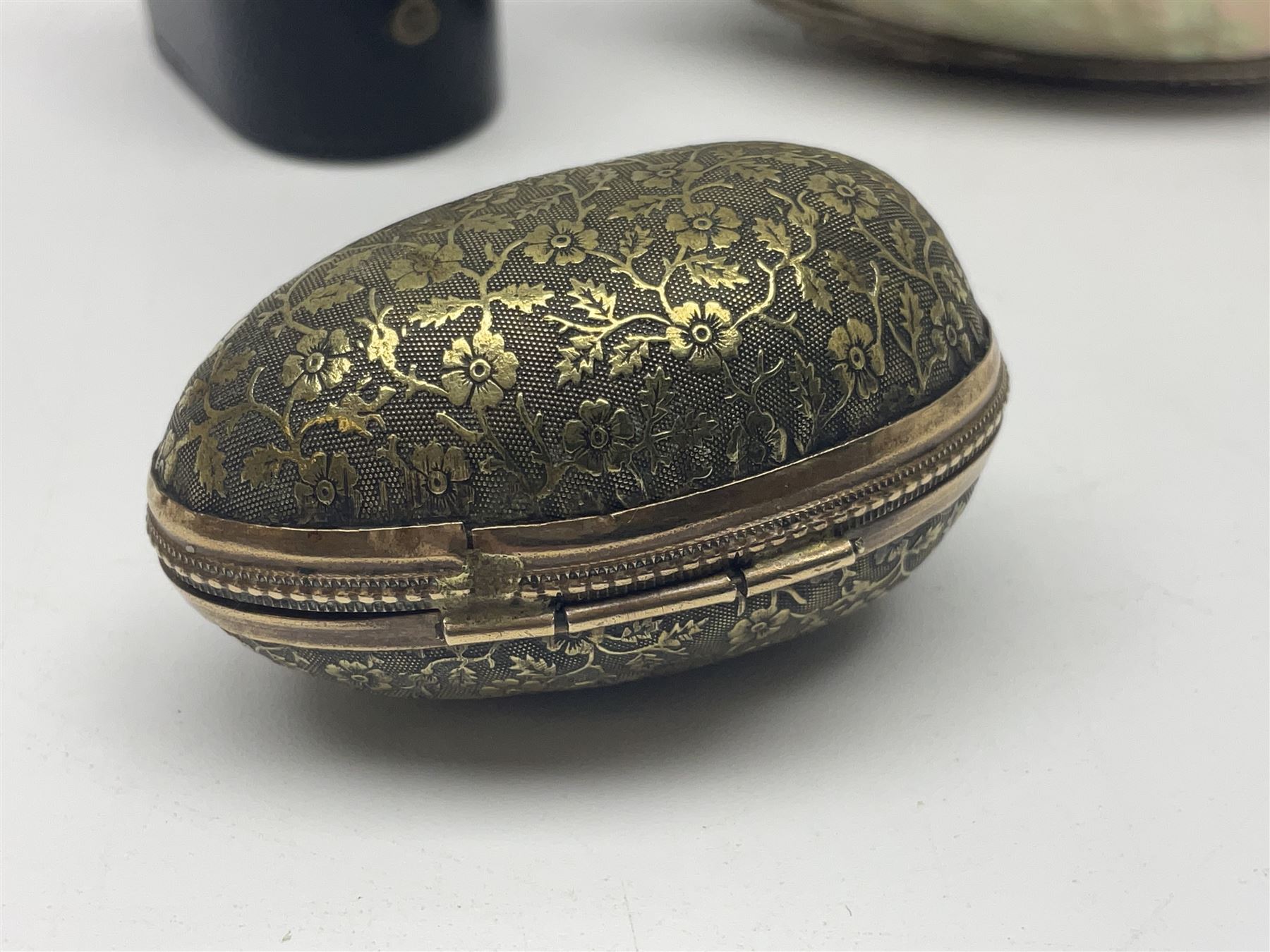 19th century lacquer thimble case with painted portrait of a woman to the hinged lid, together with two mother of pearl egg shaped thimble cases and one other