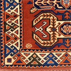 Two rugs, small Bokhara-type rug, terracotta ground with repeating hooked lozenge medallions enclosed by geometric borders (H 120cm, W 83cm); and a cream-ground rug, central lozenge medallion with geometric spandrels and border motifs (H 145cm, W 101cm),