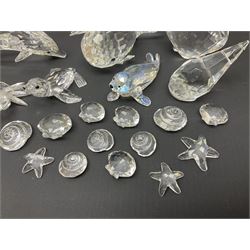 Nineteen Swarovski Crystal sea creatures, to include dolphins, seals, puffer fish, octopus, crabs, together with a quantity Swarovski Crystal shells 