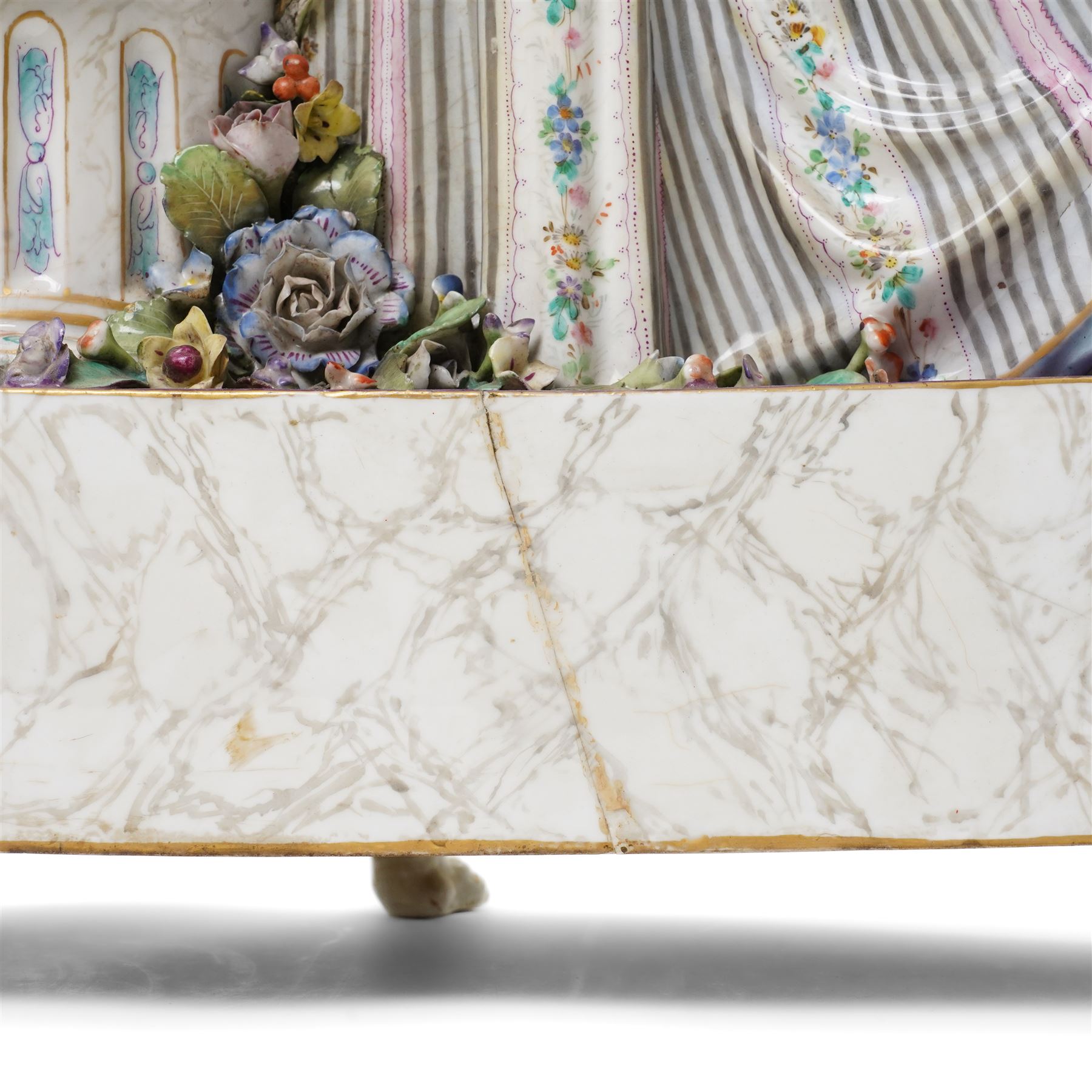 Large19th century  German porcelain mantel clock with white dial and striking movement, the case with a standing figure of Flora resting on a pillar with floral applied decoration, the base painted eith landscape and floral panels on paw feet H77cm W43cm