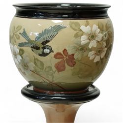 Langley Ware jardiniere and stand, decorated with birds and flowers on a light green ground, overall H93cm 