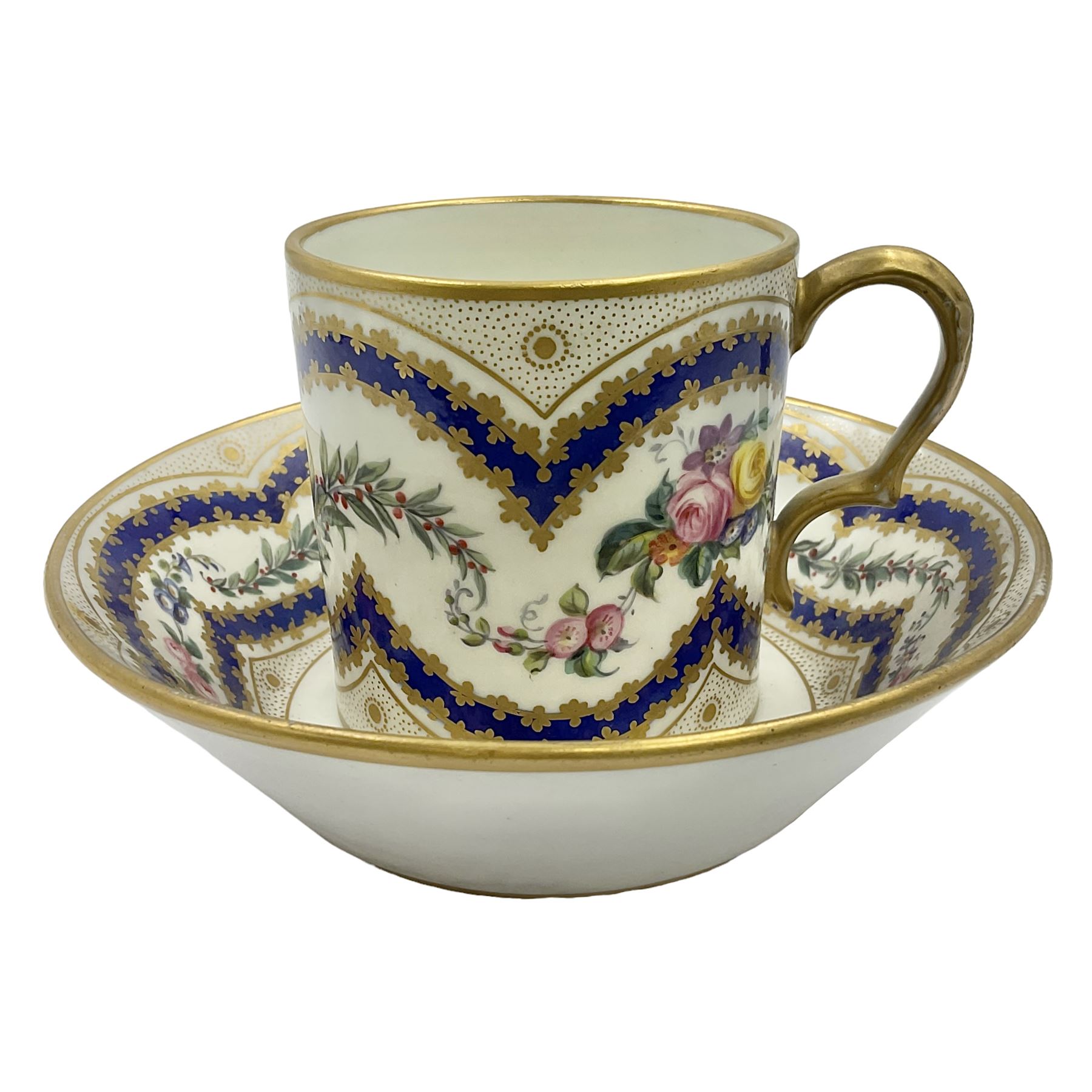 Sèvres soft paste porcelain coffee can and saucer with date code for 1767, painted with floral and laurel leaf garlands within blue scalloped and gilt borders, interlaced LL monogram enclosing the date letter O above painters mark for Catrice, coffee can H7.5cm, saucer D15cm