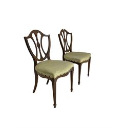 Pair late 19th century rosewood dining chairs, the shield backs pierced and carved with foliate decoration, upholstered seat over serpentine apron, raised on fluted tapered supports terminating in spade feet