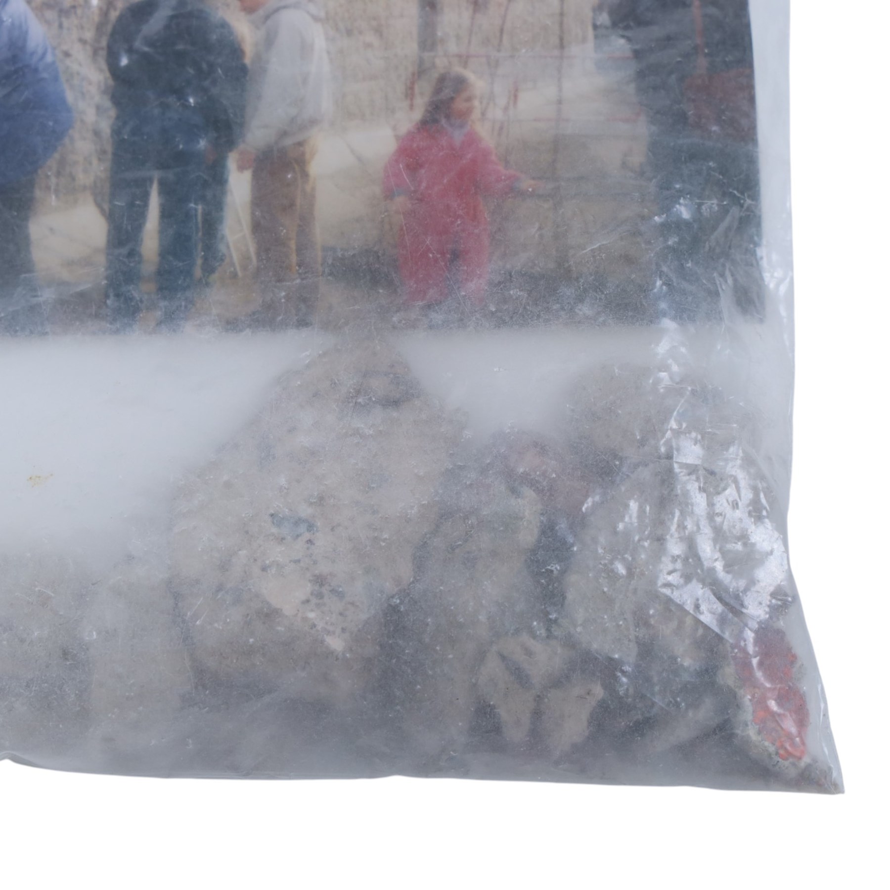 Fragment of the Berlin Wall, largest piece with blue paint to one side, with photograph and sticker to bag dated 1990