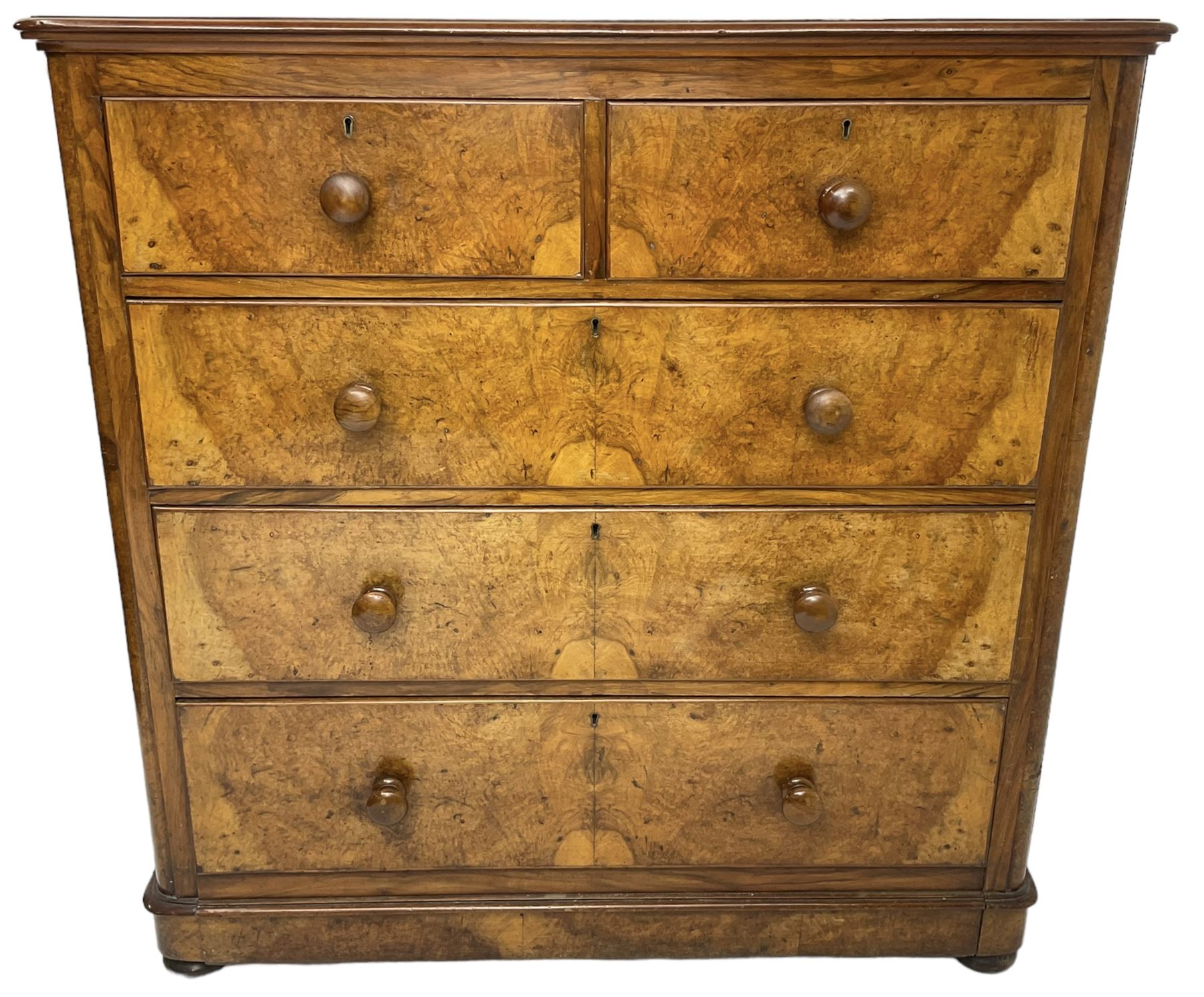 Early 20th century figured walnut chest, fitted with two short over three long drawers with bookmatch veneer facias, each with turned walnut handles, skirted base over compressed bun feet 