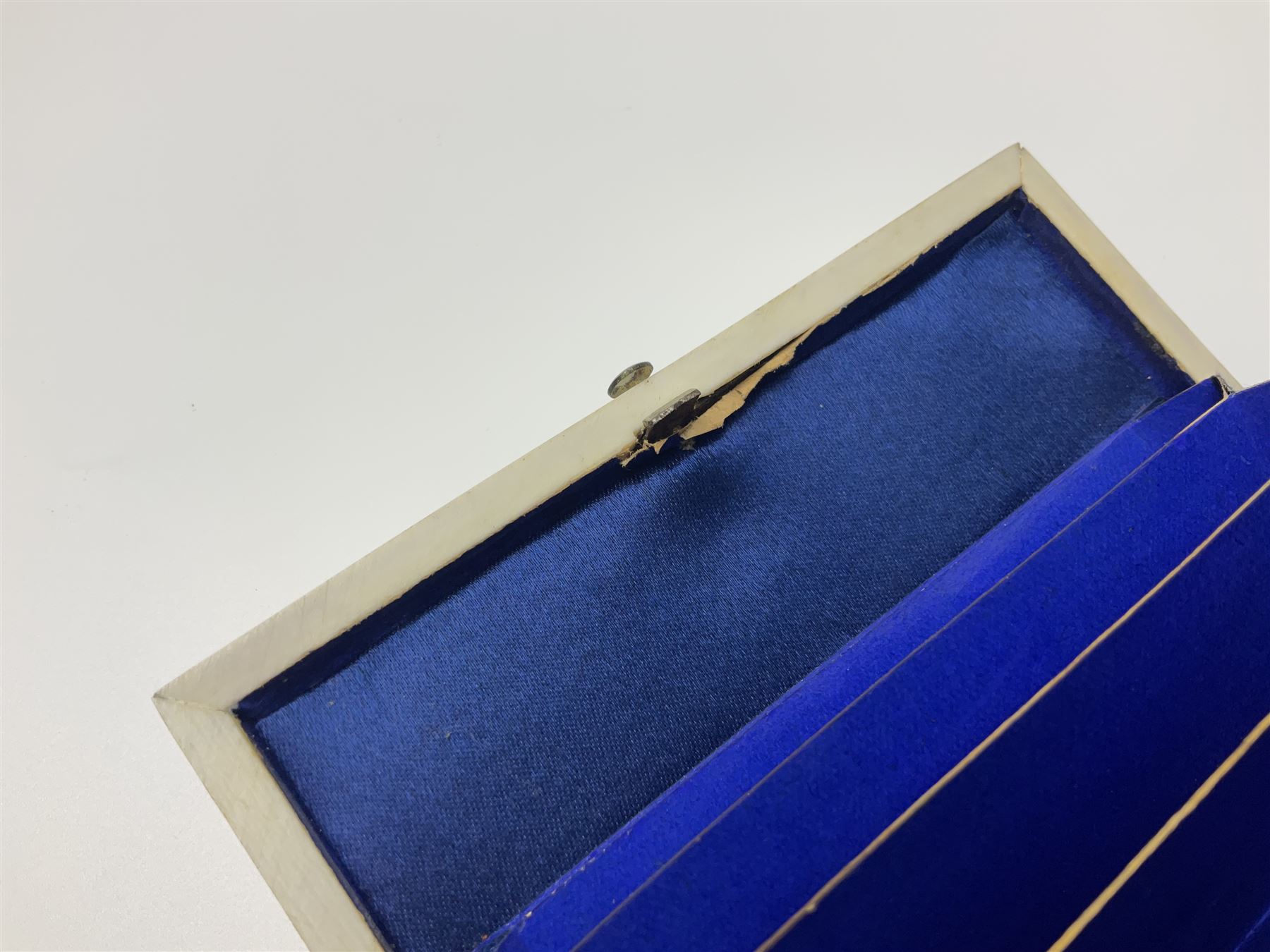 Victorian mother of pearl tea caddy, of rectangular bow-fronted form, the body with floral, bird and geometric engraved mother of pearl panels, white metal shield plaque to the cover inscribed with the initials G.J.A and similar escutcheon, the two division interior with ivory edging and two panelled mother of pearl lids, on four vegetable ivory bun feet L20cm, together with a similar style mother of pearl card case (2) This item has been registered for sale under Section 10 of the APHA Ivory Act