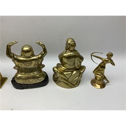 Brass buddha, with palms facing upwards on a wooden plinth, together with other brassware including two shell case vases 